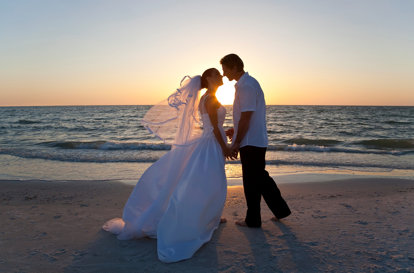 Married Couple Kissing Beach Wedding